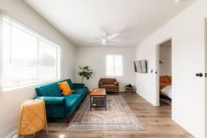 a living room with a blue couch and a table at Hidden Gem 1 Bdrm Top Floor Condo in San Diego