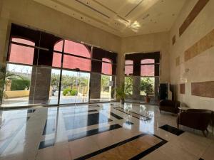 a large room with a glass table and windows at Diomond view 4 in Dubai