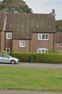 a car parked in front of a brick building at Middleton House in Norwich