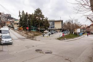 an empty street with a car parked on the road at LUXIMO ROOM in Veliko Tŭrnovo