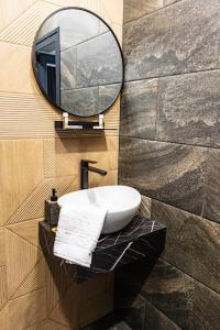 a bathroom with a sink and a mirror at LUXIMO ROOM in Veliko Tŭrnovo +28 photos