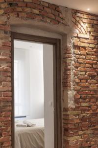 Habitación con pared de ladrillo y puerta. en Luxury flats PCL by Clabao, en Logroño