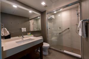 a bathroom with a sink and a shower at Hotel Dann Carlton Marinn Place Panama Financial District in Panama City