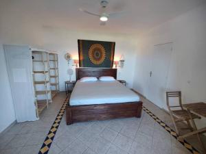a bedroom with a bed in a room with a table at Cole Bay Retreat in Koolbaai