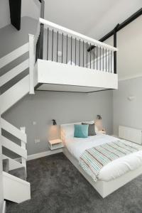 a bedroom with a white bed and a staircase at Moran's Bar & B&B in Grange