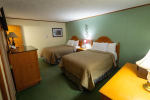 a hotel room with two beds in a room at Jimmy OConnor's Windham Mtn Inn in Windham