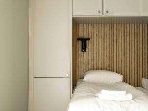 a bedroom with a white bed with towels on it at Chic Are Apt for 6 Ski-in-Ski-out with Sauna in Åre