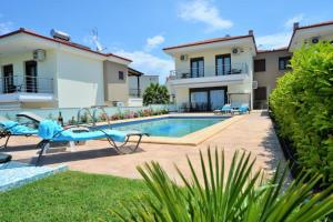 a villa with a swimming pool and a house at Villas Hanioti in Hanioti