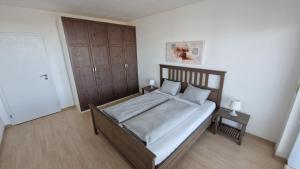 a bedroom with a large bed and two night stands at Sunny Apartment with amazing Terrace on the 13th floor near City Center in Bratislava