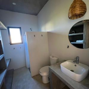 a bathroom with a sink and a toilet and a mirror at habitación en Casa Palma y Coco in Playa Agua Blanca +11 photos