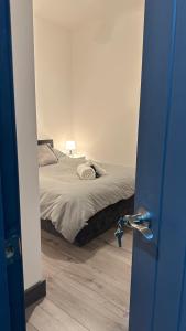a bedroom with a bed and a door with a door at Modern 2 Bed near Turf Moor Football Stadium, Parks, Canal and Lake in Burnley