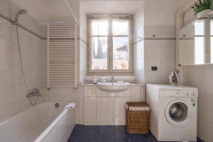 a bathroom with a sink and a washing machine at Apartment Julia - Menaggio in Menaggio