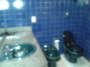 a bathroom with two toilets and a sink at Motel Comodoro (Adult Only) in Rio de Janeiro