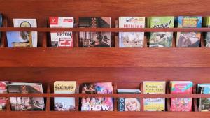 a wooden book shelf filled with lots of books at Church Farm Guest House in Horsford