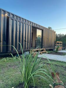 a small house with a corrugated metal facade at Apart Containers, Acantilados in Mar del Plata +30 photos