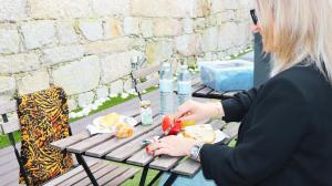 una mujer sentada en una mesa de picnic comiendo comida en MyStay Porto Bolhão, en Oporto