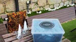 a plastic container sitting on a wooden bench with a box at MyStay Porto Bolhão in Porto