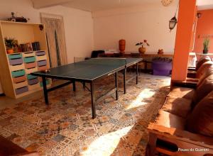 a ping pong table in a living room at Pouso do Guarani - 200m do mar|wifi|Ar cond in Florianópolis