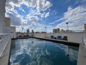 a swimming pool on the roof of a building at MH 10201 - Estiloso Studio com WF/AC/Cama Queen in São Paulo