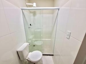 a white bathroom with a toilet and a shower at Studio #3 Rubi in Campos dos Goytacazes