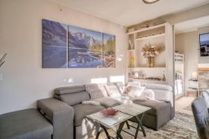 a living room with a couch and a table at Mountain Escape sleeps 10 Guests in this 3BD 2BT Top Floor Condo with Mountain View in Canmore