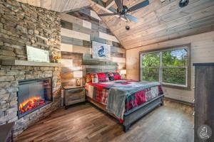 a bedroom with a stone wall and a bed and a fireplace at The Water Fox in Sevierville with Indoor Pool, Hot Tub, Game Rm, and Theater in Sevierville +66 photos