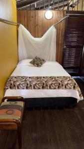 1 dormitorio con 1 cama grande y mosquitera en Posada Turística Rocas De Cabo Marzo, en Bahía Solano