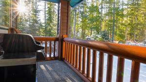 a balcony of a cabin with a view of trees at Polar Peak Chalet by Fernie Lodging Company in Fernie