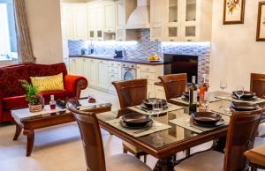 a kitchen and living room with a table and chairs at Boutique Villa Aspasia in Lixouri +42 photos