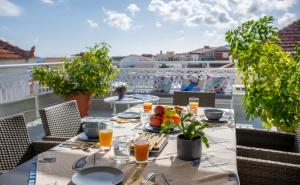 a table with food and drinks on a balcony at Boutique Villa Aspasia in Lixouri