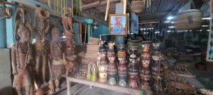 a store with a bunch of masks and other items at Auberge chez M in Ganvié