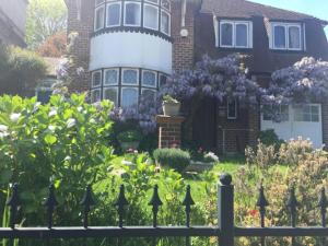 a house with a fence in front of it at Livadia House at St Leonards on Sea in St. Leonards