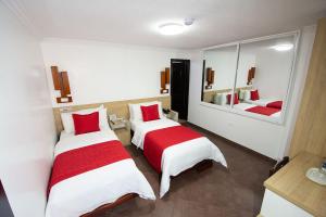 Postel nebo postele na pokoji v ubytování Hotel Plaza Victoria