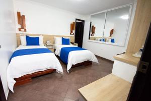 Postel nebo postele na pokoji v ubytování Hotel Plaza Victoria