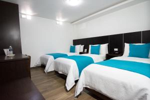 Postel nebo postele na pokoji v ubytování Hotel Plaza Victoria