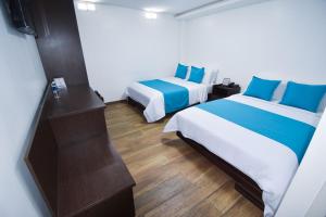 Postel nebo postele na pokoji v ubytování Hotel Plaza Victoria