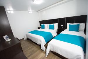 Postel nebo postele na pokoji v ubytování Hotel Plaza Victoria