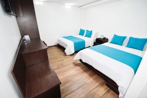 Postel nebo postele na pokoji v ubytování Hotel Plaza Victoria