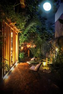 a patio with a table and chairs at night at Hotel Boutique Terra Diaguita & Spa in La Serena