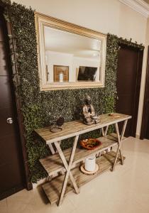 a table with a mirror on a green wall at Casa Panda near Airport / Shopping Plaza and International Border in Tijuana