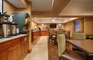 a kitchen with a dining room with a table and chairs at Best Western Plus Mishawaka Inn in South Bend