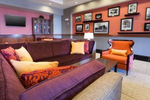 a living room with a couch and two chairs at Drury Inn & Suites Cincinnati Sharonville in Sharonville