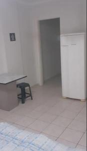 a room with a table and a chair and a refrigerator at Apartamento inteiro, completo para até 8 pessoas por locação Não é divido com outros pessoas apenas significa que vc pode locar que tem capacidade para até 8 pessoas mas a locação sempre é individual de quem locou in Campinas