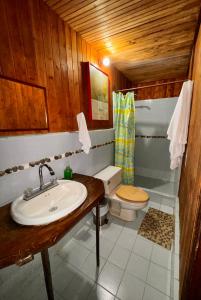 a bathroom with a sink and a toilet at Posada Turística Rocas De Cabo Marzo in Bahía Solano