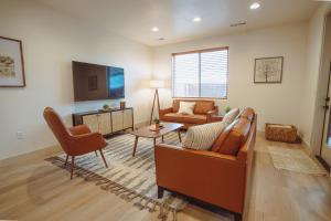 a living room with a couch and a tv at Harper House in Santa Clara