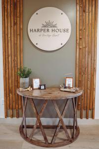 a table with a harper house sign on a wall at Harper House in Santa Clara