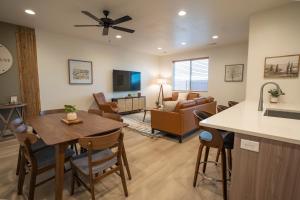 a kitchen and living room with a table and a couch at Harper House in Santa Clara