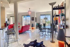 a living room with a table and chairs at Superb 2 bedroom apartment with sea view on the Croisette in Cannes