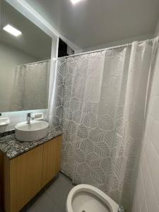 a bathroom with a shower and a toilet and a sink at Calido departamento en Mendoza in Mendoza