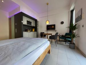 a bedroom with a large bed and a dining room at The East Apartment by Rabe - Netflix & Coffee & Parkplatz in Karlsruhe